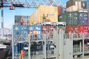 A team of dockworkers at work on a container ship in Rotterdam